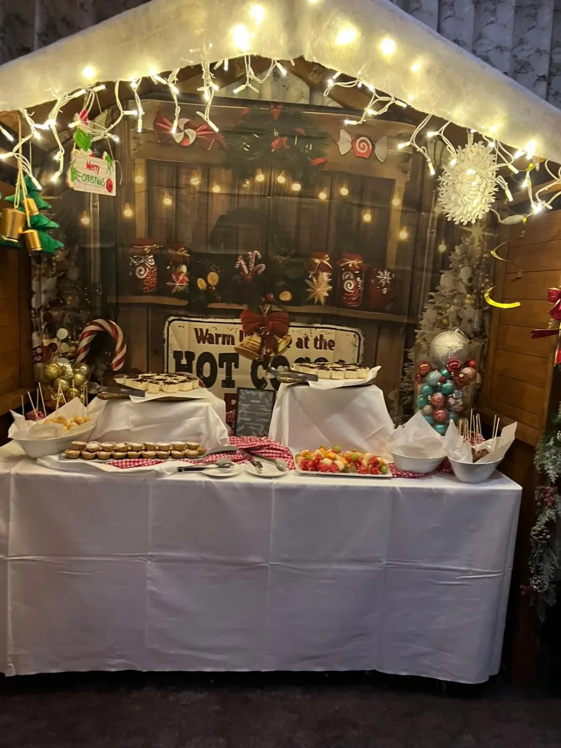 A decorated service counter surrounded by warm lights and greenery.