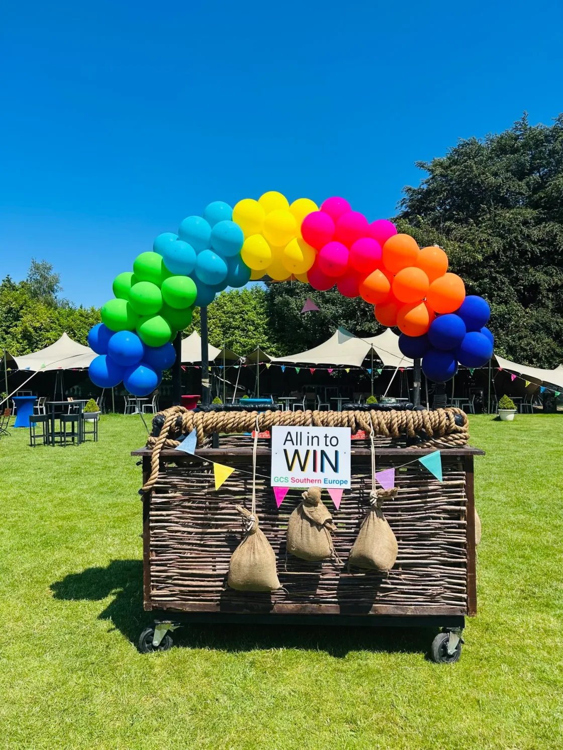 A rainbow balloon arch and wicker basket styled for the Summer Celebration Carnival in Dublin.