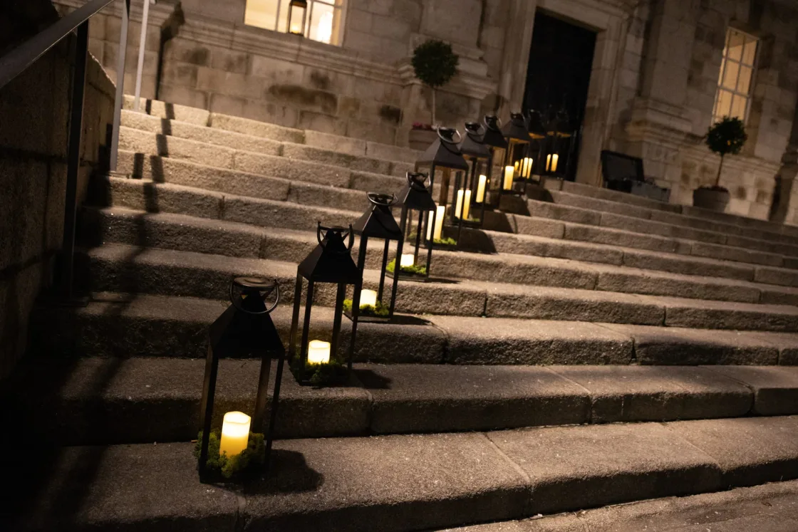 Black candle lanterns arranged along wide stone steps.