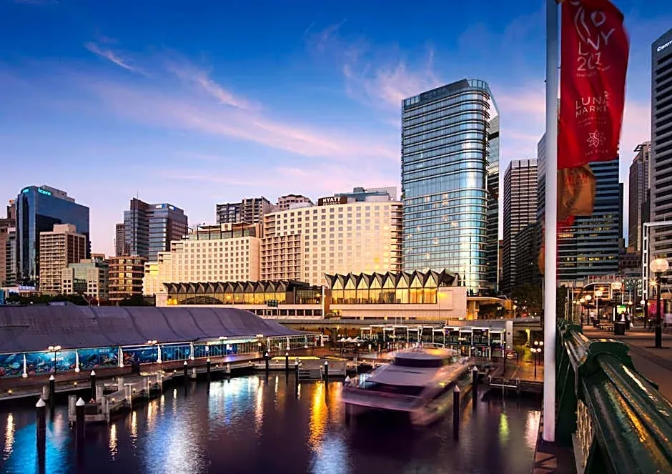City buildings reflected in a river at dusk.