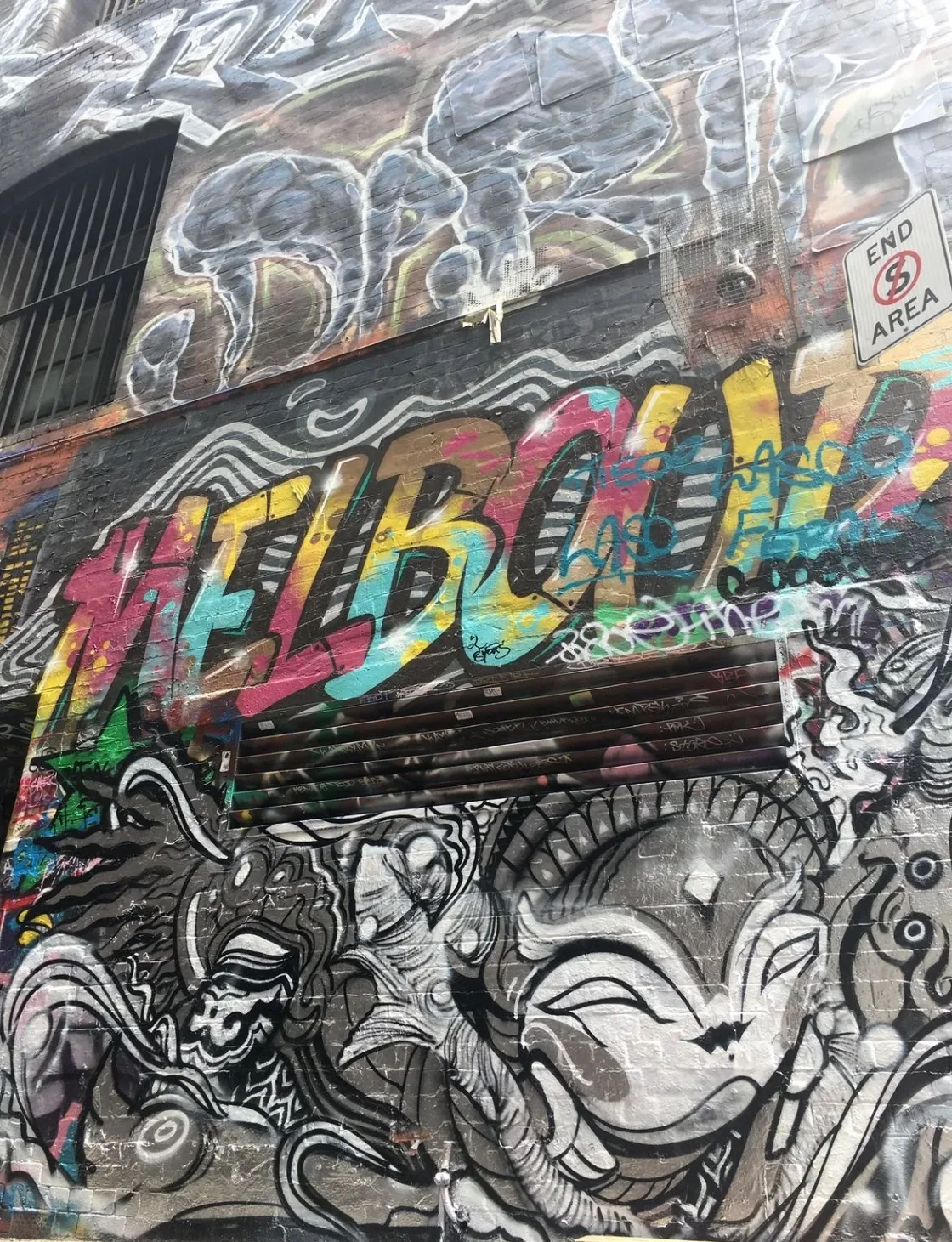 Colourful Melbourne lettering on a densely painted street-art wall.