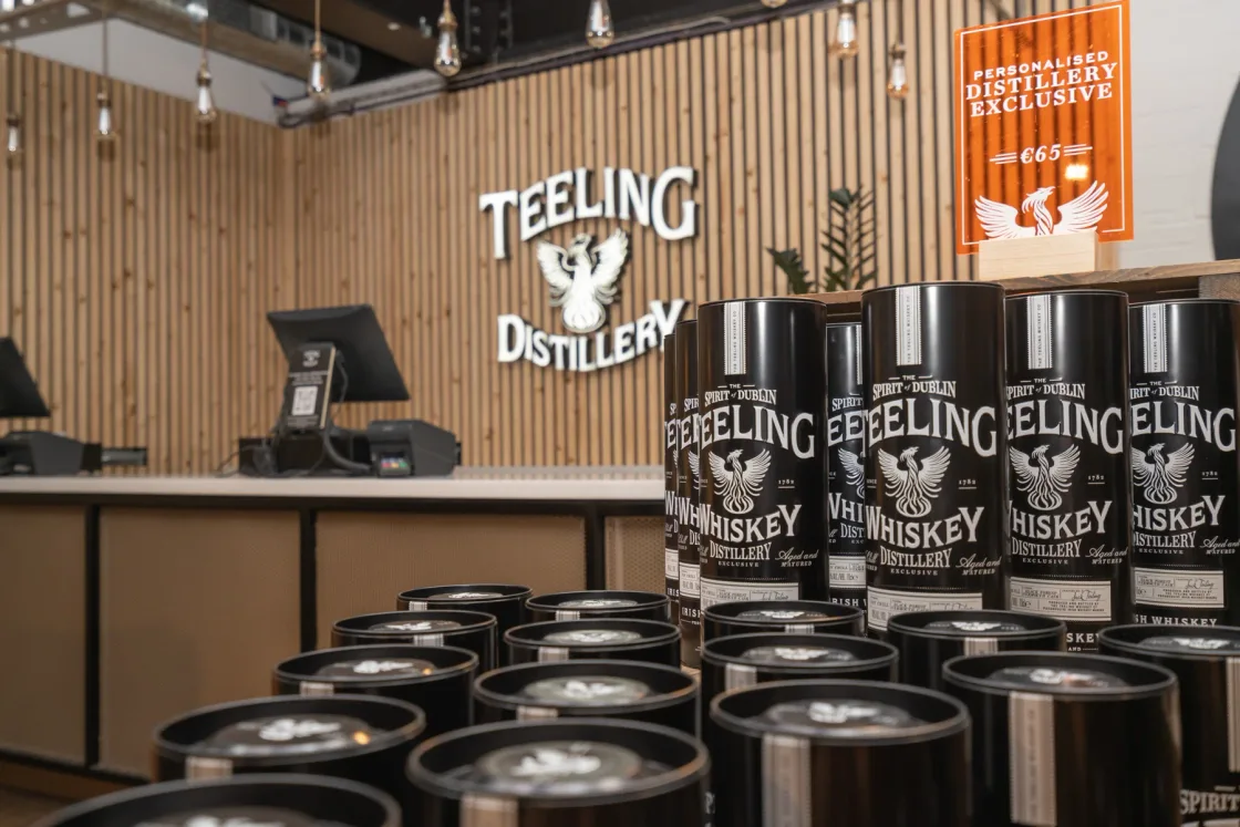 Branded Teeling Whiskey tasting cups arranged at a distillery counter.