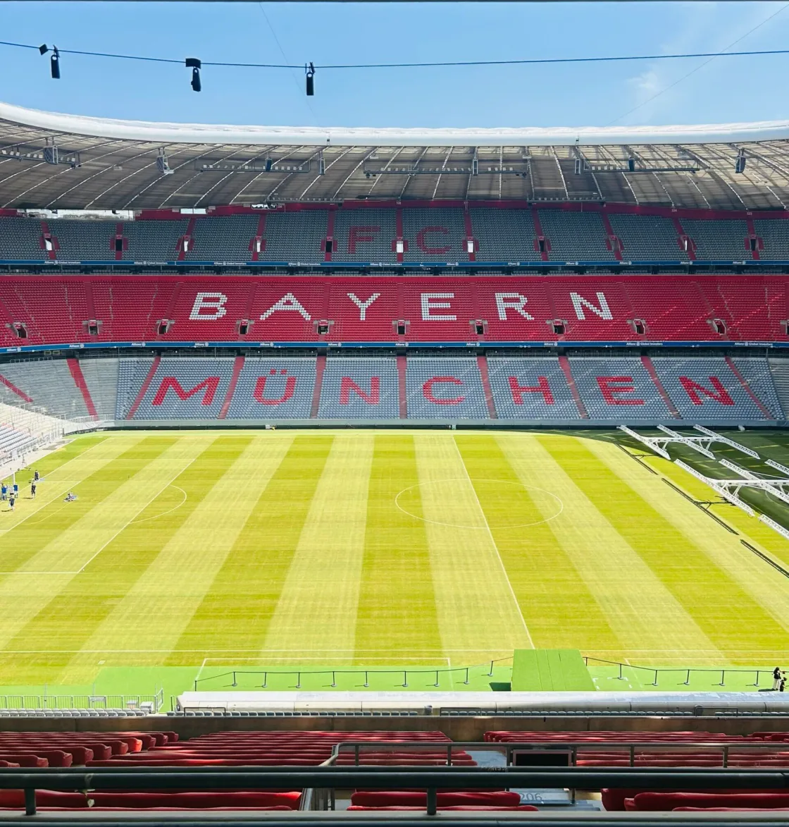 The pitch and red seating inside the Bayern Munich stadium.