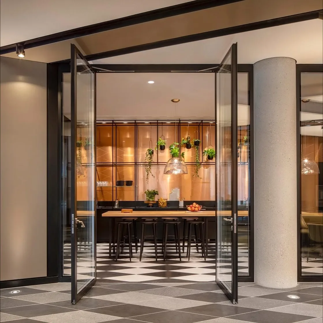 A meeting room viewed through an open glass doorway.
