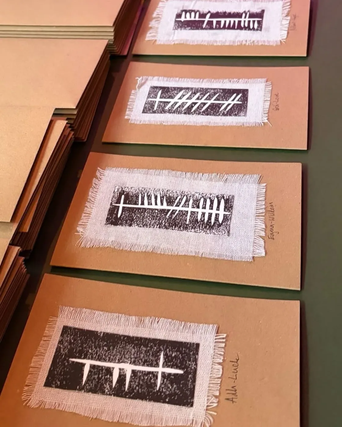 A row of framed prints displayed on a wall.