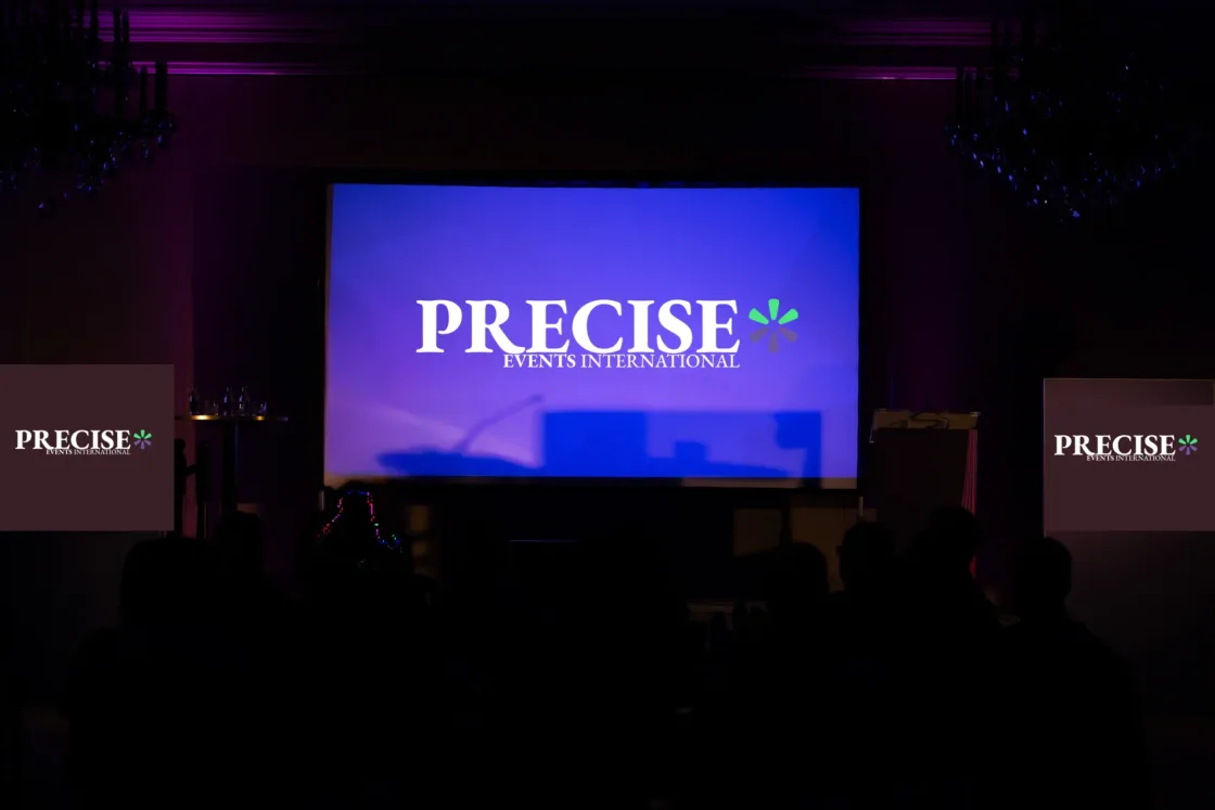PRECISE branding on violet conference screens at the Engineering Leadership Summit.