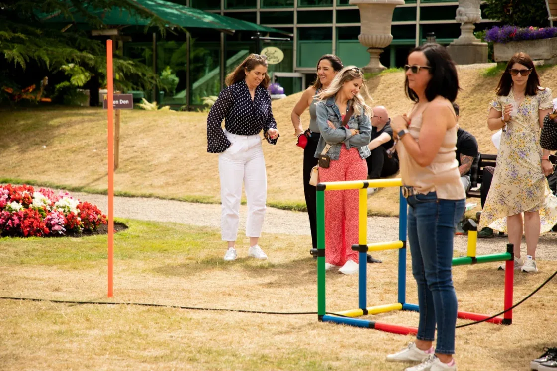 Guests taking part in a lawn game with coloured frames.