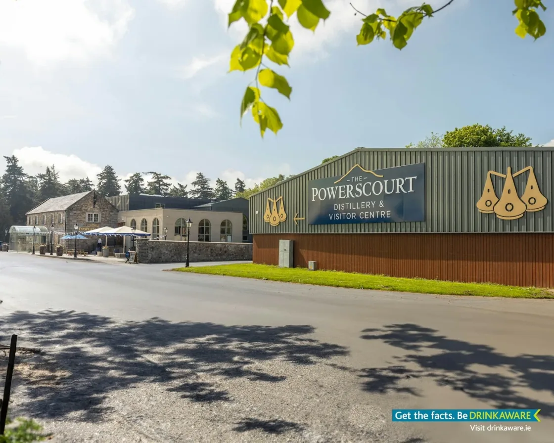 The entrance to Powerscourt Distillery with signage and landscaped grounds.