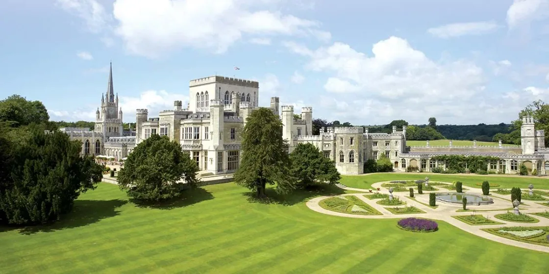 A country estate with a castle-like house and formal gardens.