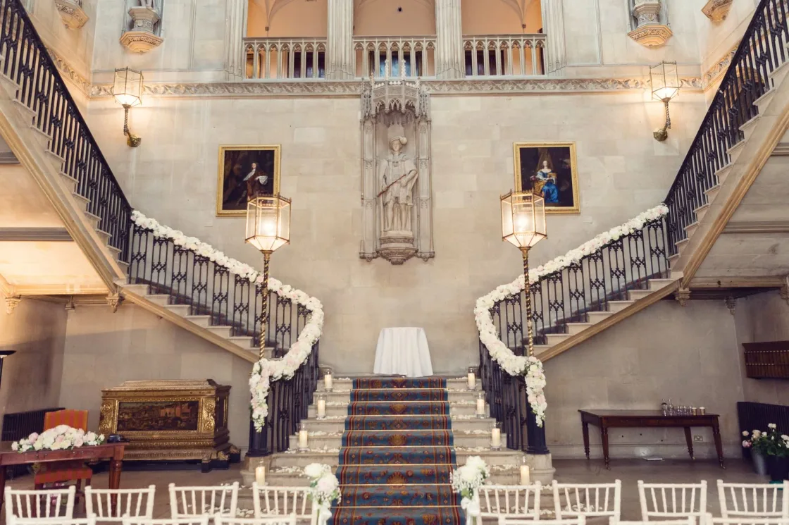 A grand double staircase above rows of chairs arranged for an event.